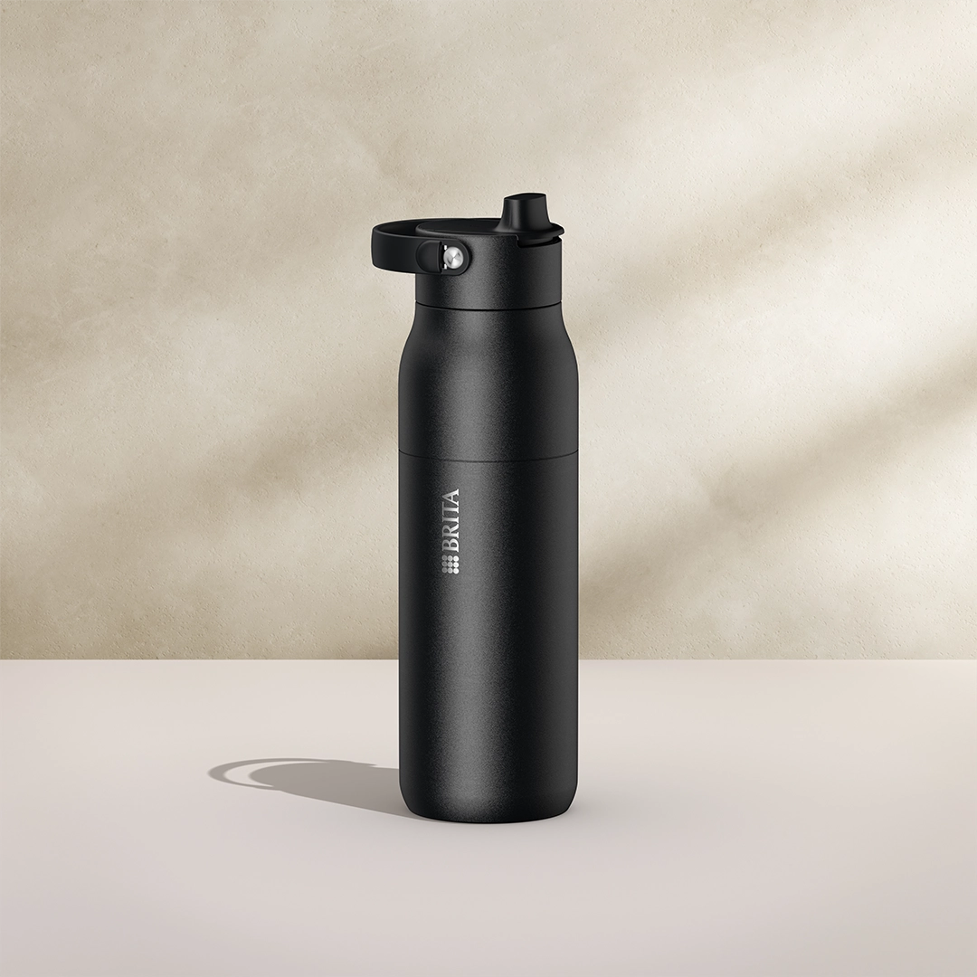 BRITA LARQ Essential Fles, 1000 ml, in het zwart op een beige achtergrond.